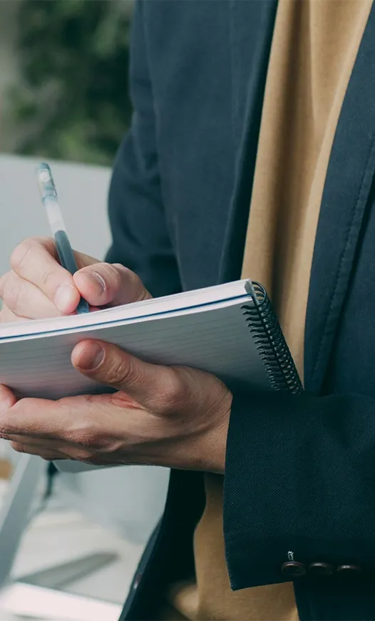 Advisor taking notes during a client conversation