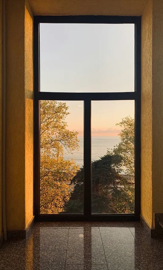 Autumn landscape framed by a large window
