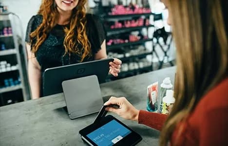 Retail business owner assisting a customer